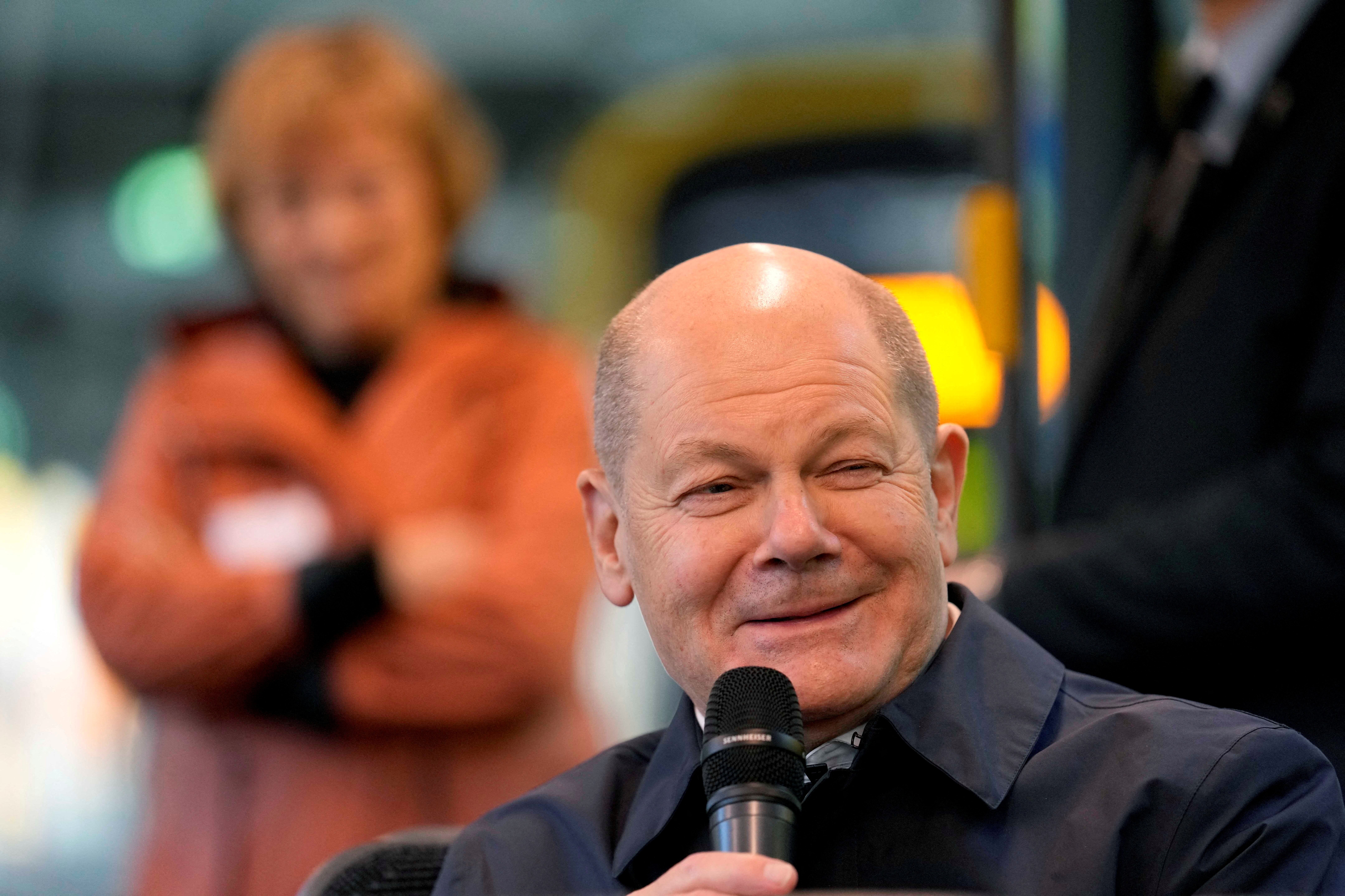 FILE PHOTO: German chancellor Olaf Scholz sits in a tram as he talks to participants of the Democracy project 'metro-polis' in Dresden