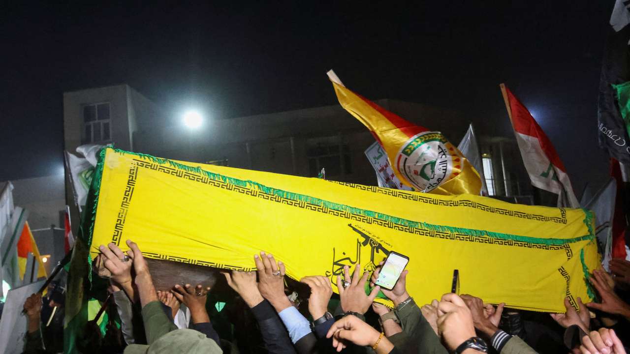 People carry the coffins of members of Harakat al-Nujaba killed by a U.S. military strike, in Baghdad