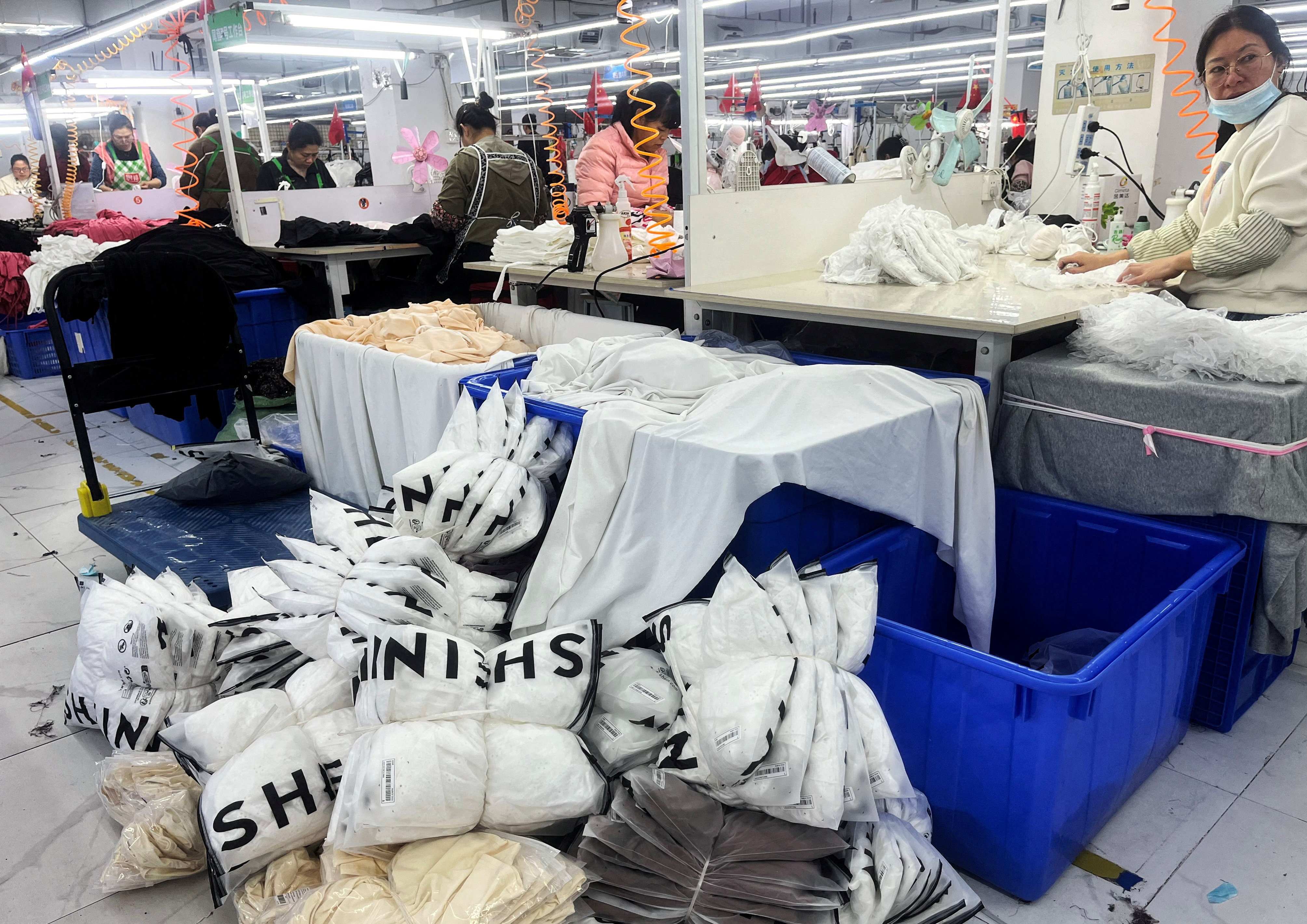 FILE PHOTO: FILE PHOTO: Workers work at a production line manufacturing clothing for Shein at a factory in Guangzhou