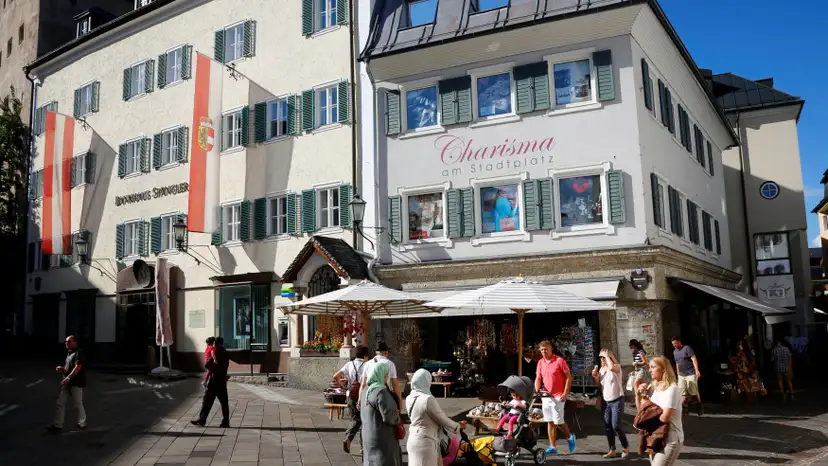 Arab tourists walk past a souvenir shop in Zell am See