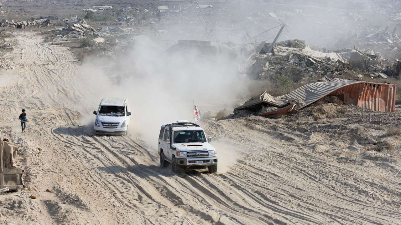 A Red Cross vehicle, escorted by a van driven by a Hamas militant, moves in an area within the so-called "yellow line" to which Israeli troops withdrew under the ceasefire, in Gaza City