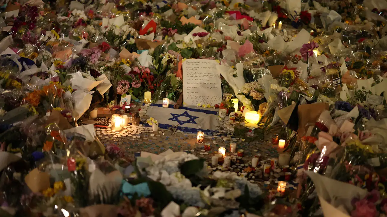 An Israeli flag sits amongst floral tributes honouring the victims of a shooting at Jewish holiday celebration on Sunday at Bondi Beach, in Sydney