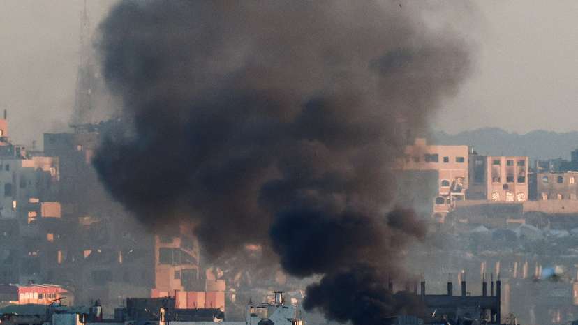 Smoke rises from a burning building in North Gaza, as seen from the Israel-Gaza border