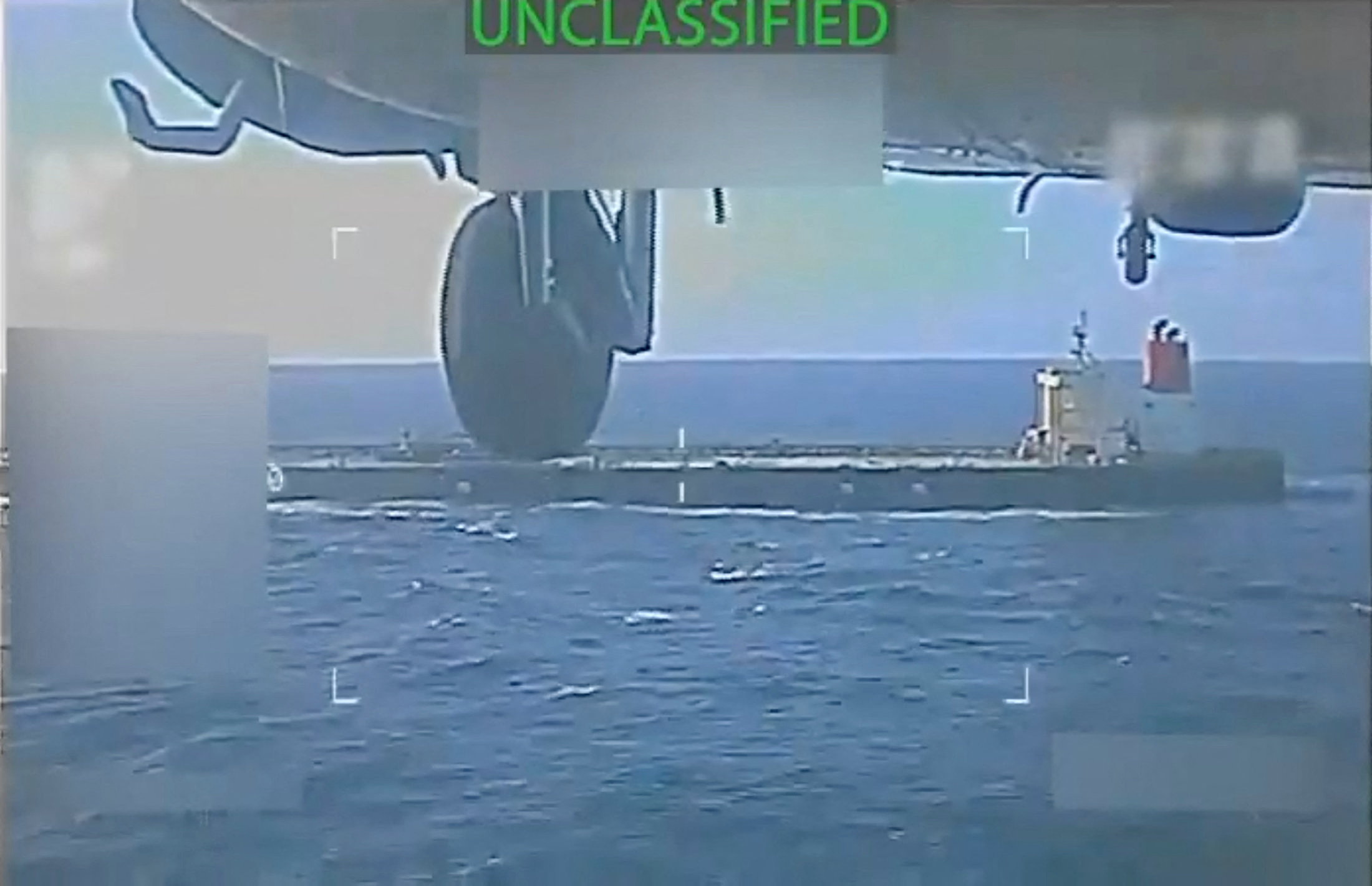 U.S. military helicopter flies near an oil tanker during its seizure by the United States off the coast of Venezuela