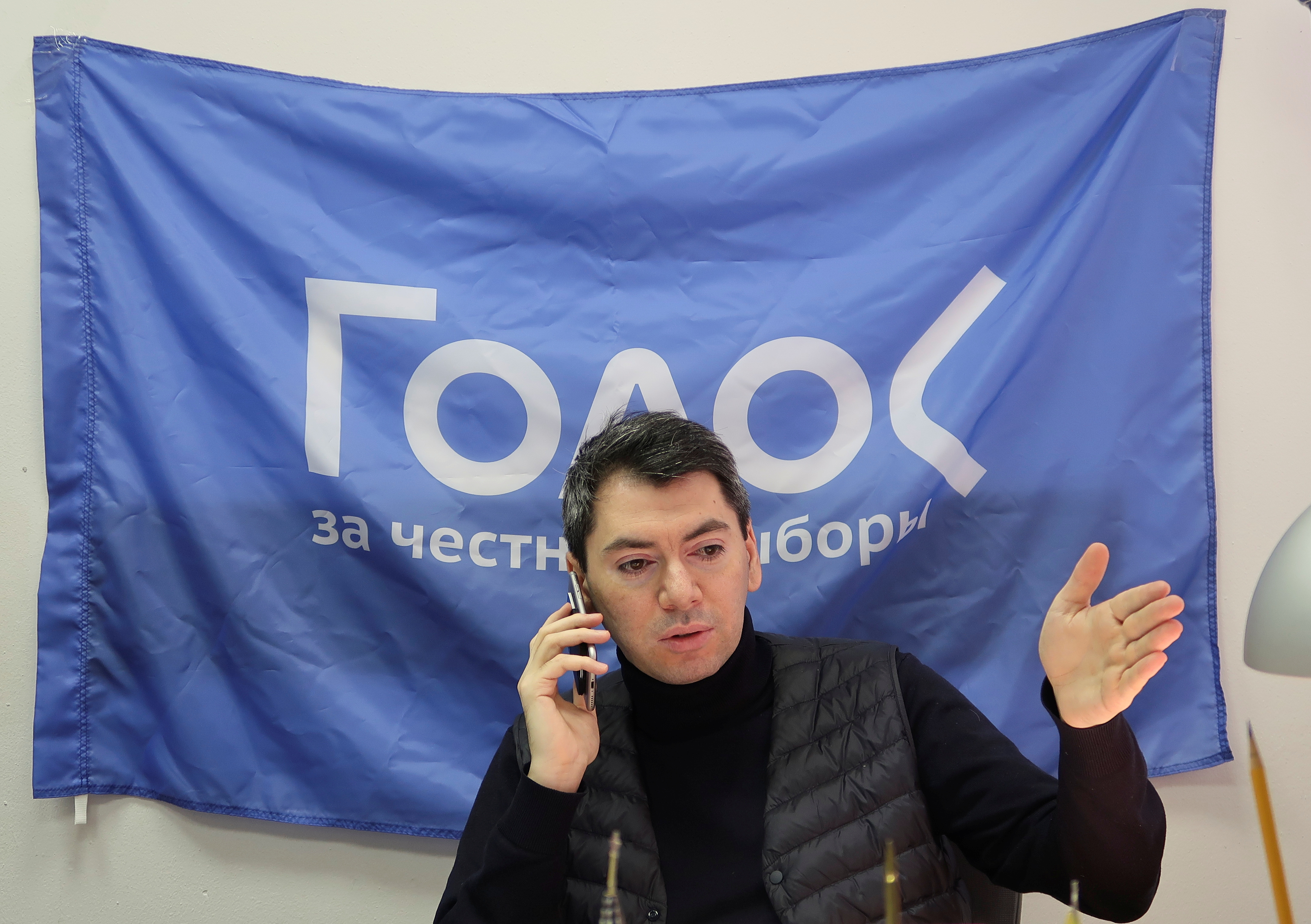 Co-chairman of Golos non-governmental organisation Melkonyants speaks on the phone at his office in Moscow