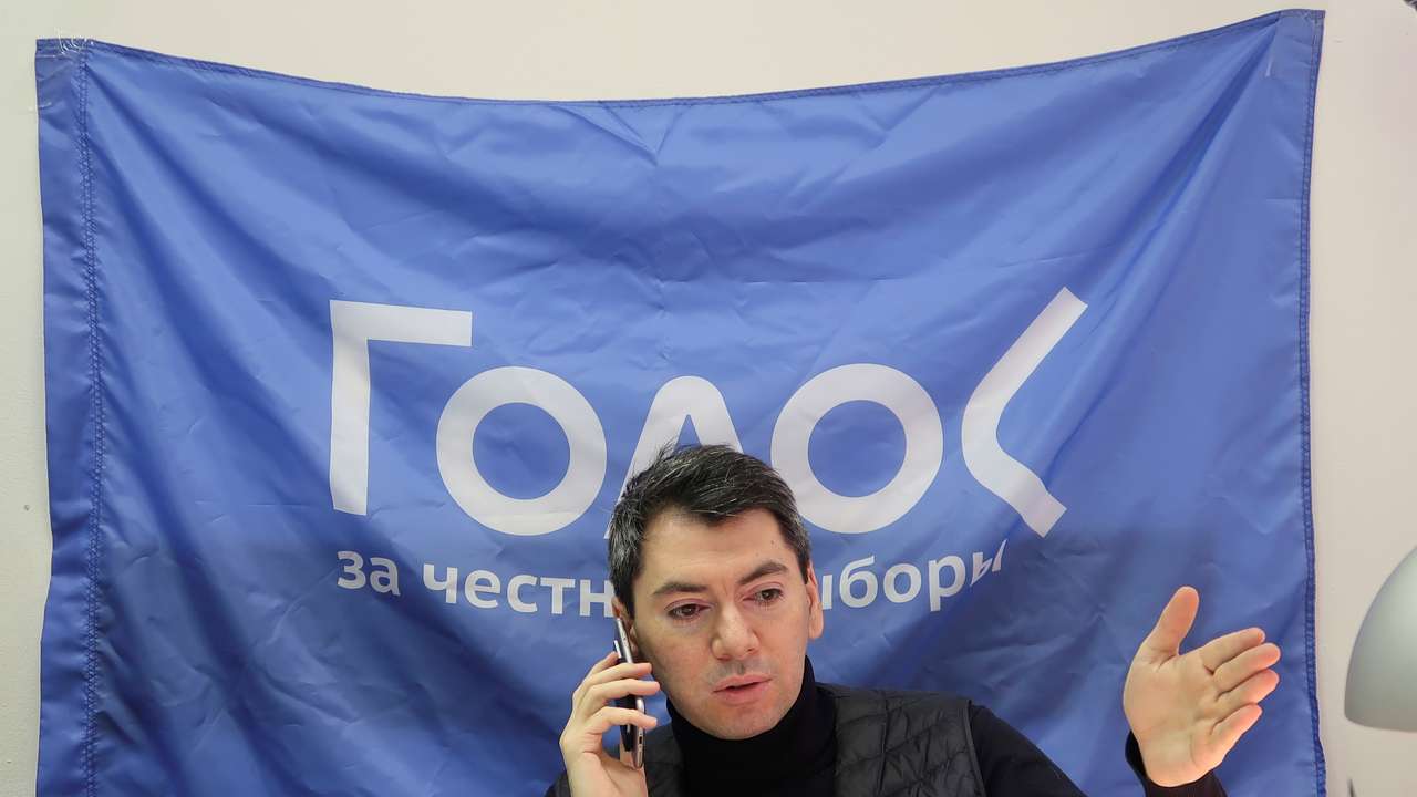 Co-chairman of Golos non-governmental organisation Melkonyants speaks on the phone at his office in Moscow