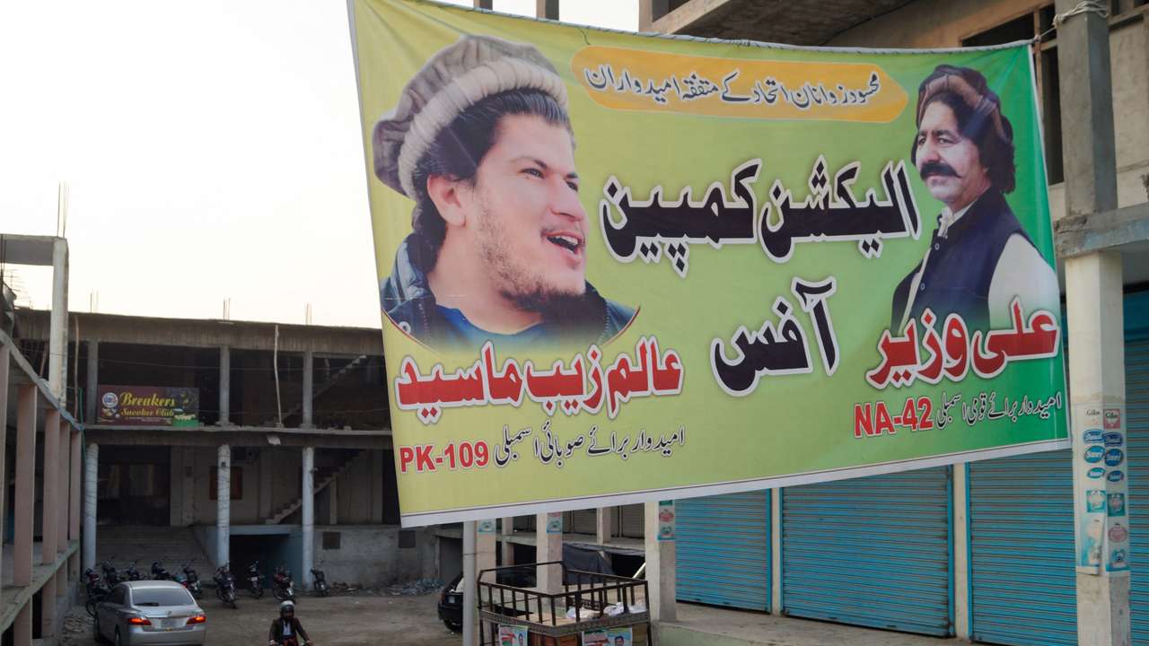 Election campaign banner of Ali Wazir and Alam Zeb Mehsud, independent candidates for general election from South Waziristan, hangs over a street in Dera Ismail Khan