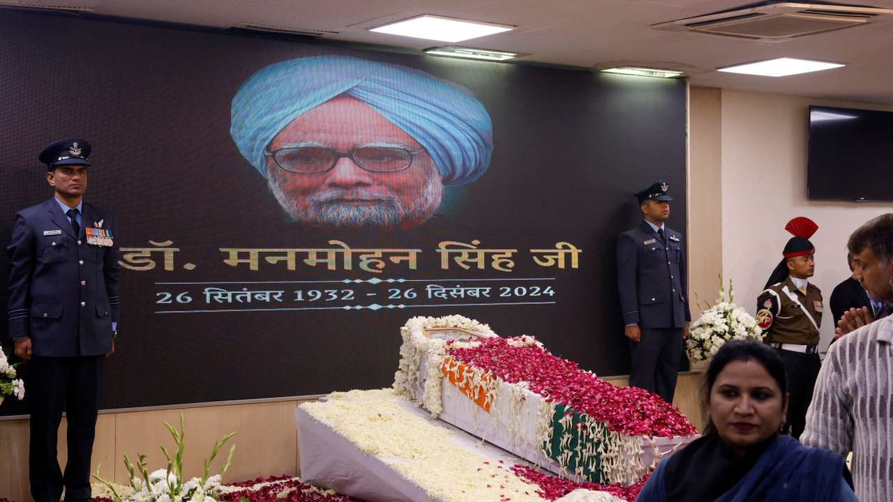 People arrive to pay their respect to India's former PM Singh at the Congress party’s headquarters in New Delhi