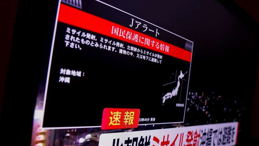 A TV screen displays a warning message called "J-alert" after the Japanese government issued an emergency warning, saying a missile had been launched from North Korea, in Tokyo
