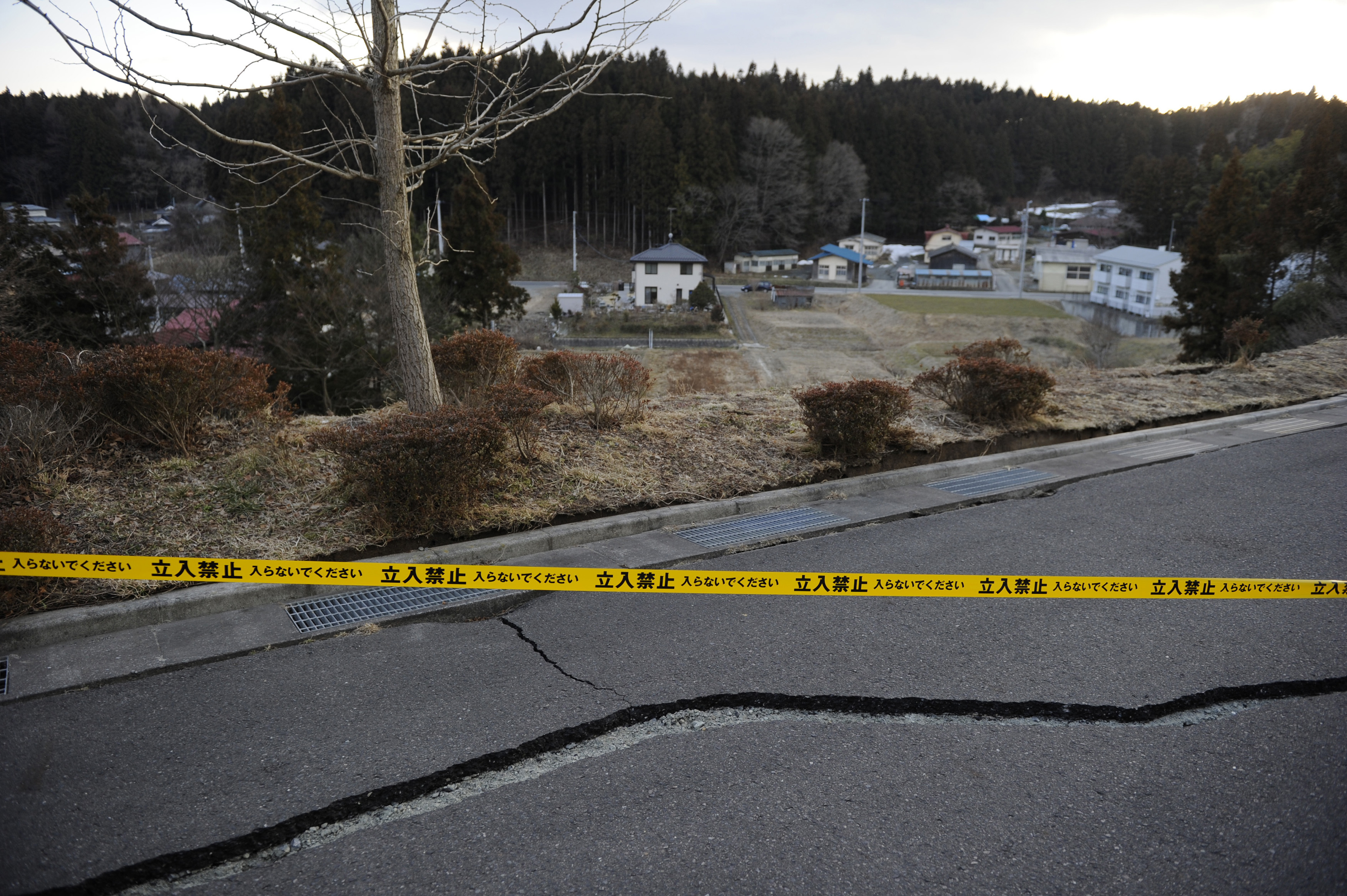 A police tape barring cars and people from entering, is placed across an area in Ono