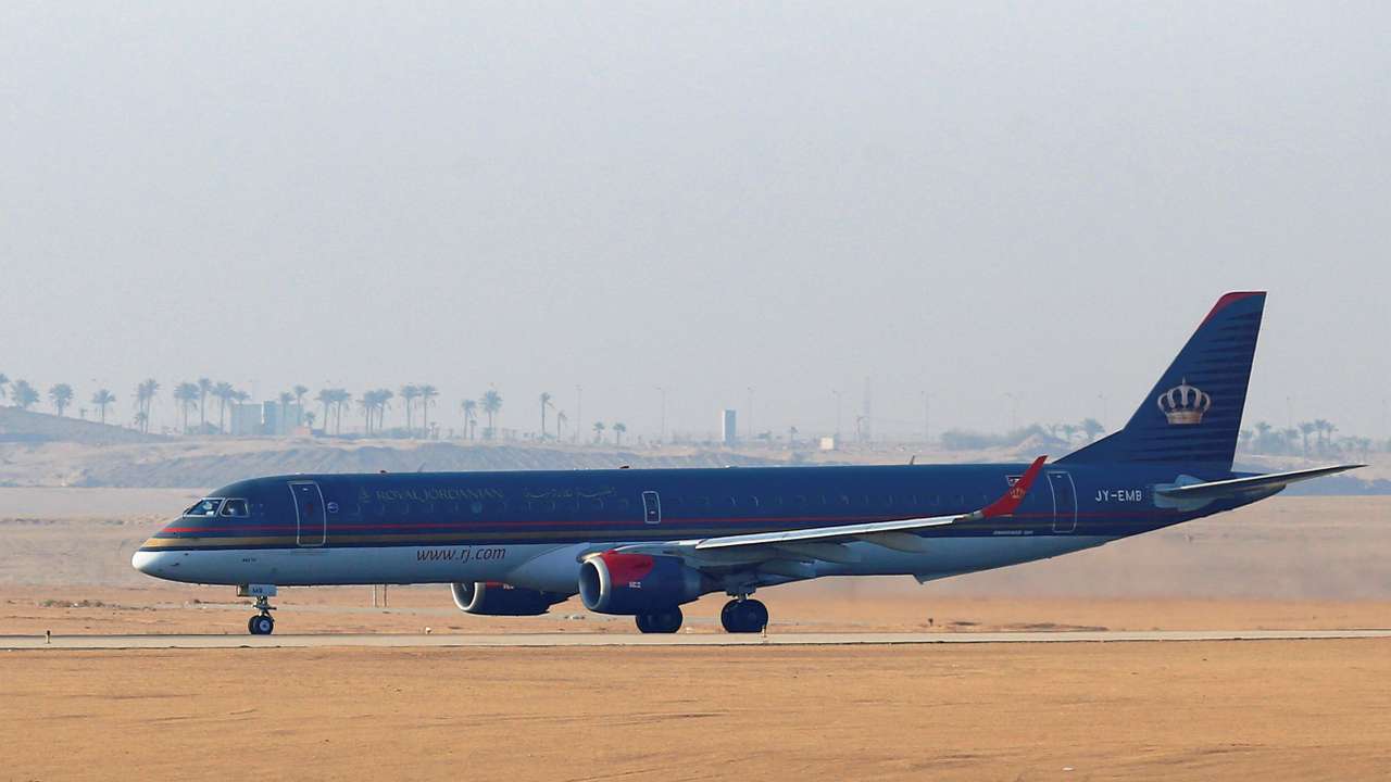 A Royal Jordanian Airlines Embraer ERJ-195AR plane waits to take off on the runway at Cairo Airport