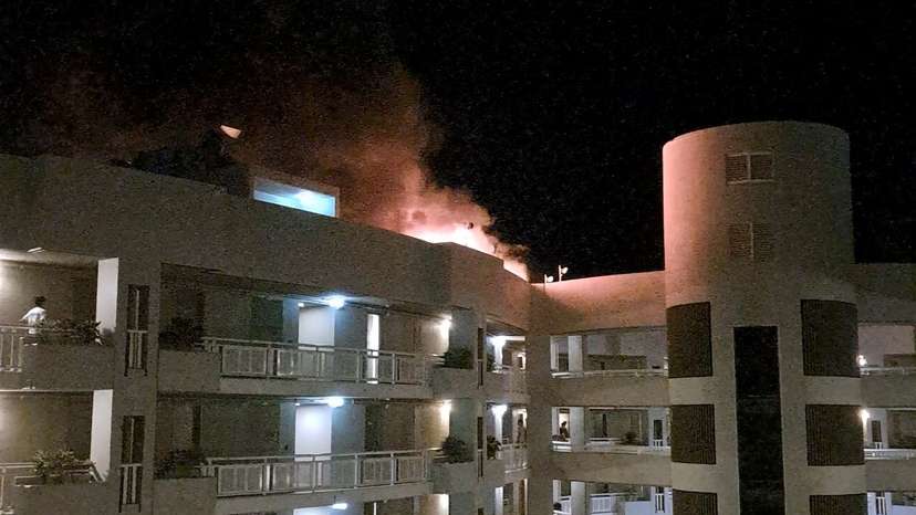 A fire burns at the Double Tree Hotel after a helicopter crashed into the roof in Cairns