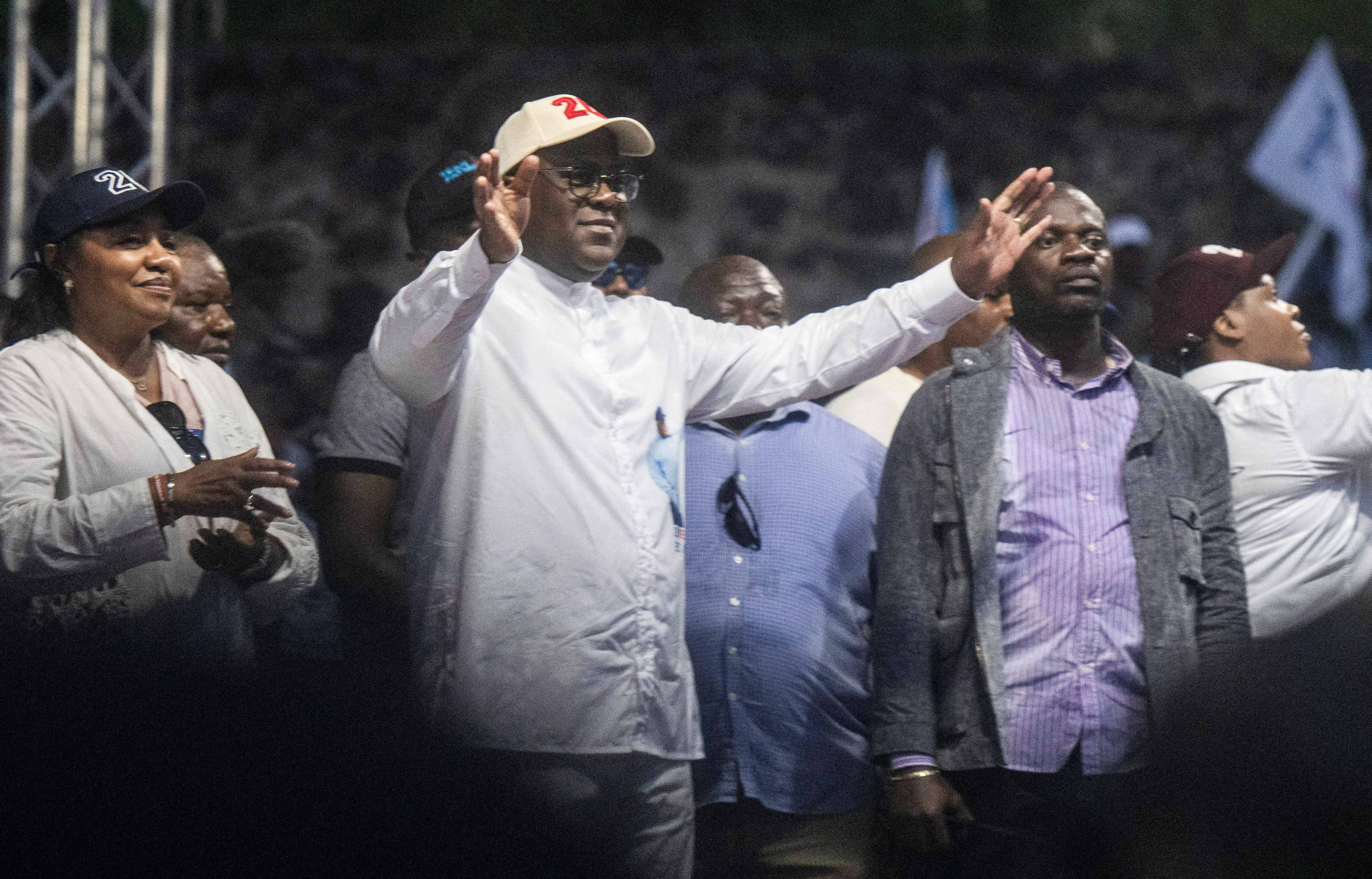 FILE PHOTO: Democratic Republic of the Congo's President Felix Tshisekedi flanked by first lady Denise Nyakeru salute supporters during a campaign rally at the Afia stadium in Goma