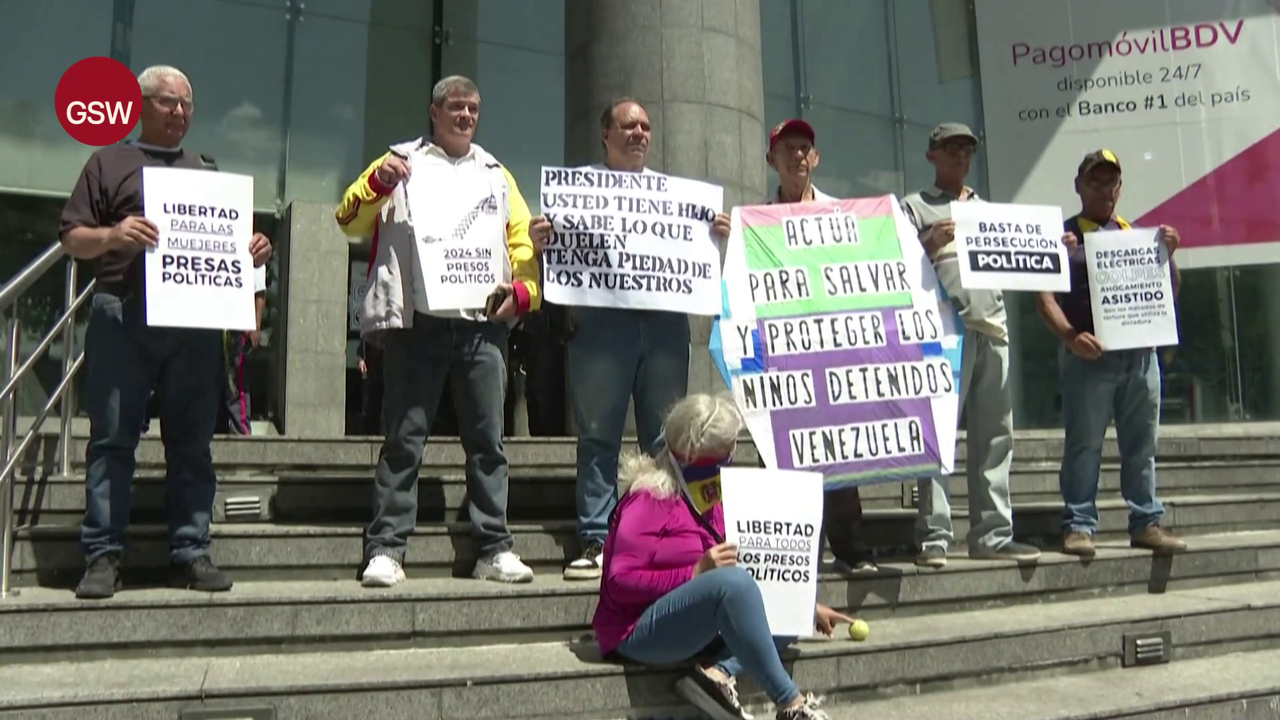 Relatives of detained adolescents hold banners outside UNICEF offices