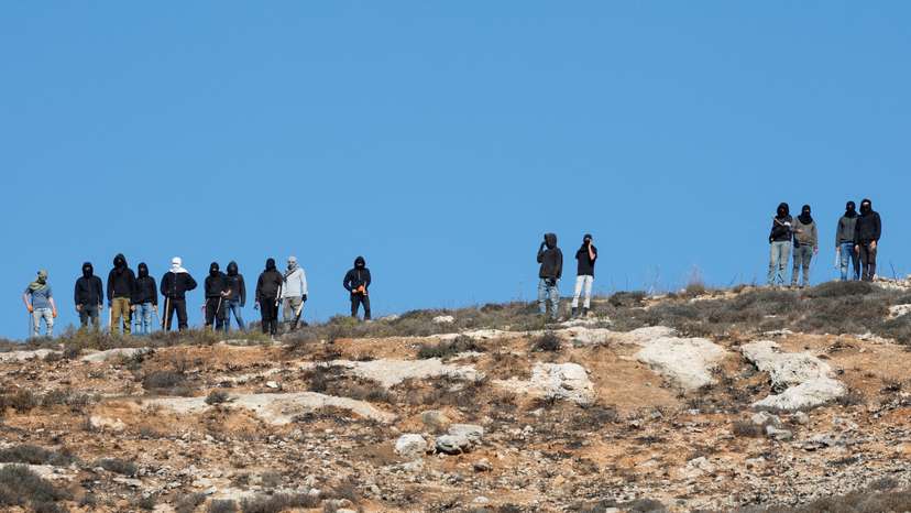 FILE PHOTO: Israeli troops deny Palestinian farmers access to harvest olives, in Burqa