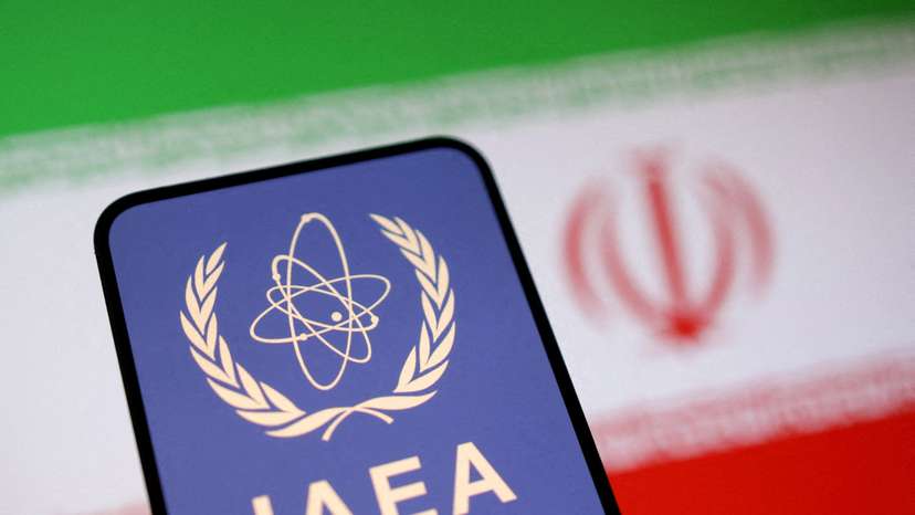 FILE PHOTO: Illustration shows International Atomic Energy Agency (IAEA) logo and Iranian flag