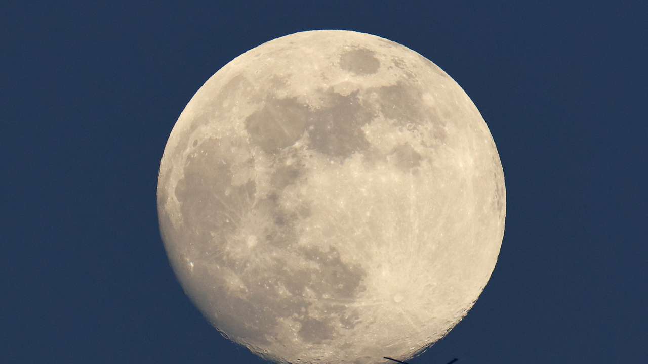 Apache helicopter passes in front of the moon, near the Israel-Gaza border