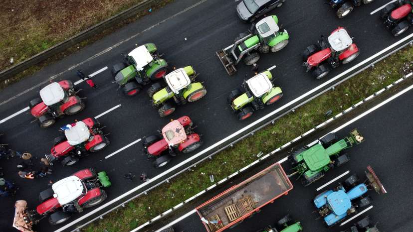 French farmers use their tractors to block the A1 highway near a highway toll station in Chamant