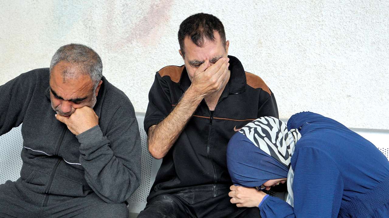 Mourners react next to the bodies of Palestinians killed in an Israeli strike, at Abu Yousef al-Najjar hospital in Rafah
