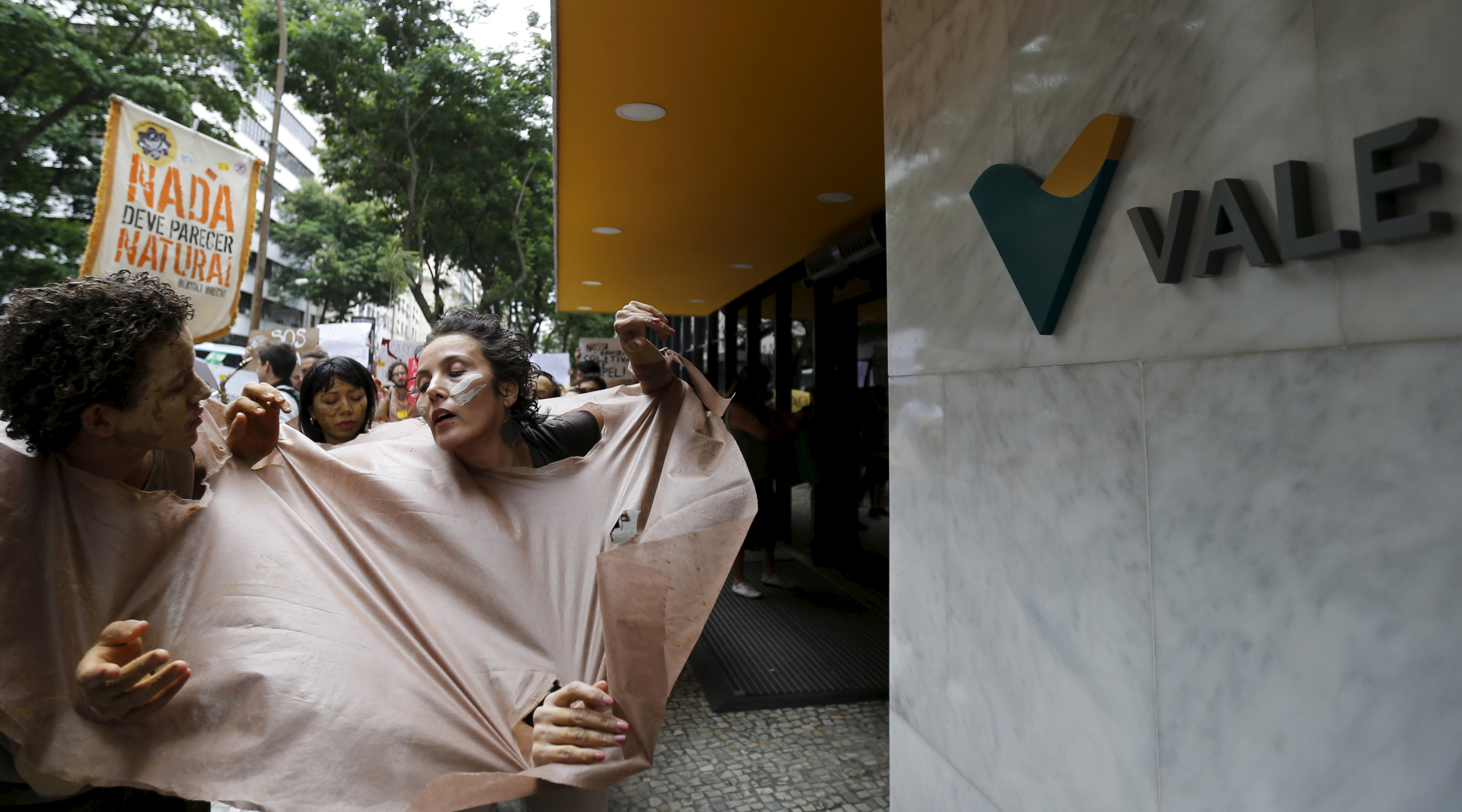 Environmental activists perform during a protest in front of the headquarters of Brazilian mining company Vale SA in downtown Rio de Janeiro