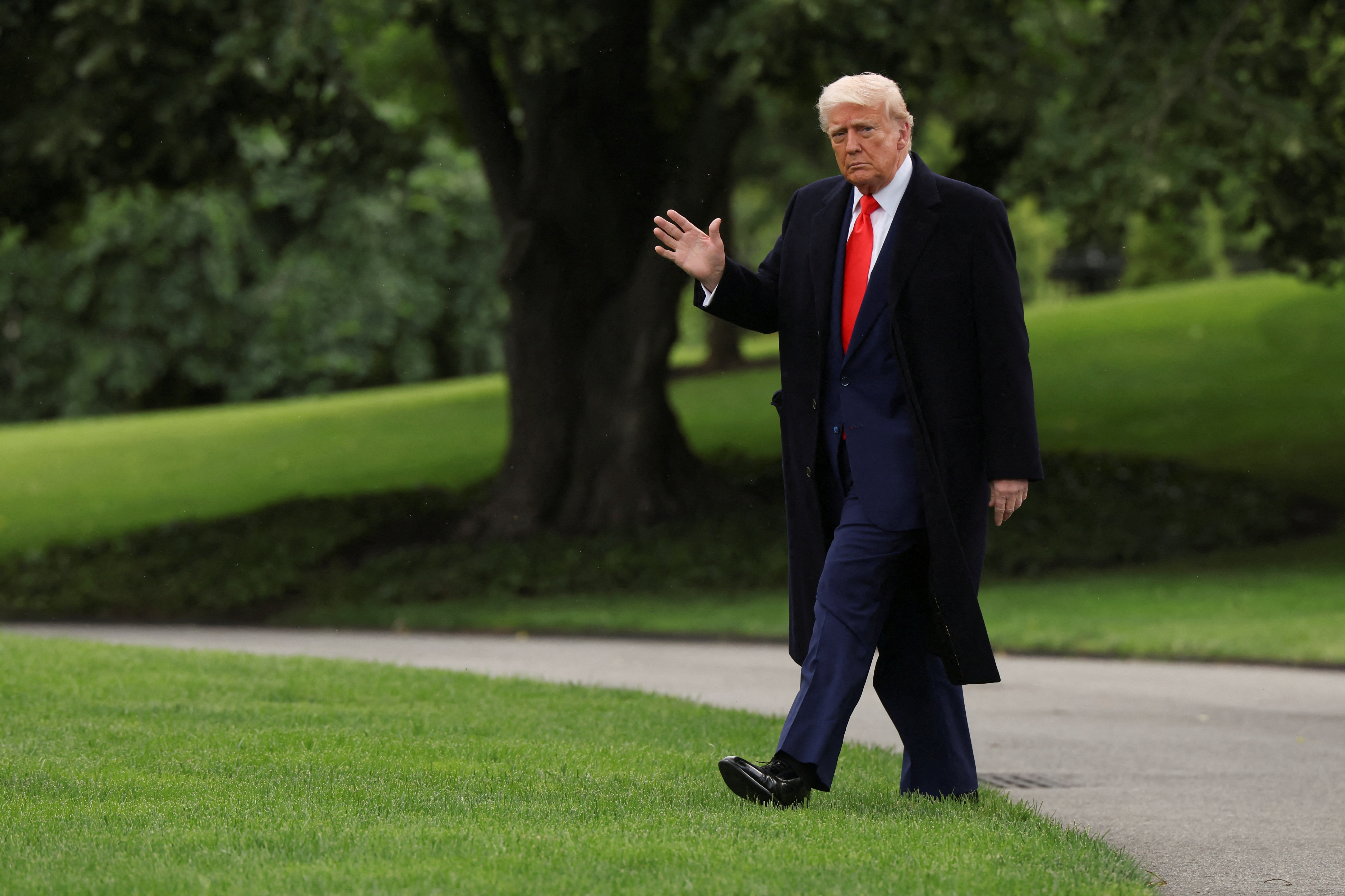 U.S. President Donald Trump walks as he departs the White House to attend his meme coin gala at the Trump National Golf Club