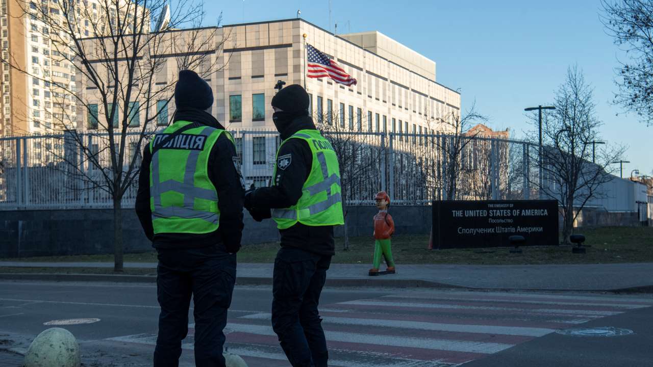 Police officers stand outside the U.S. embassy in Kyiv