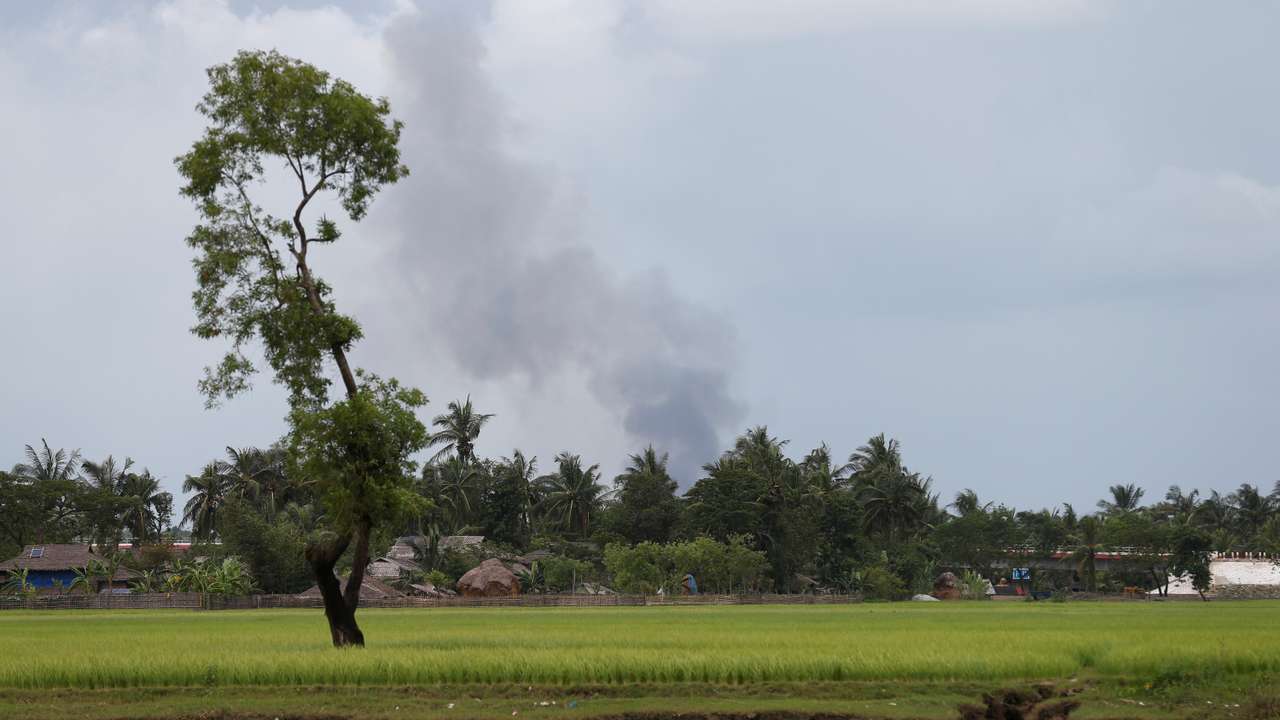 Fire smokes are seen over a village in Buthidaung