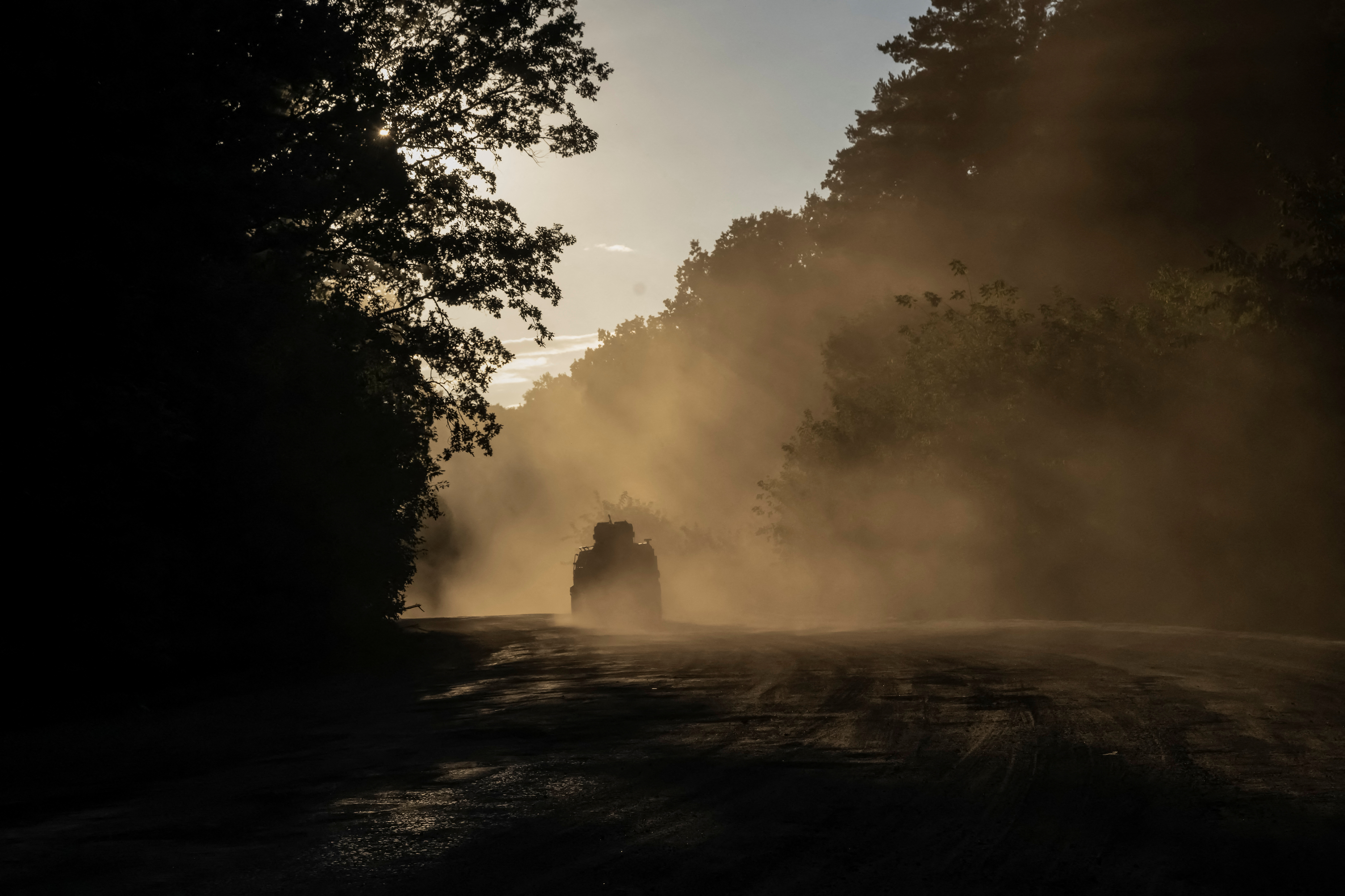 Ukrainian servicemen ride a military vehicle near the Russian border in Sumy region