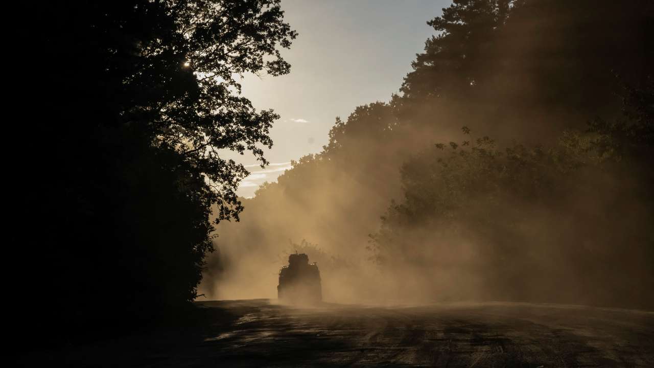 Ukrainian servicemen ride a military vehicle near the Russian border in Sumy region