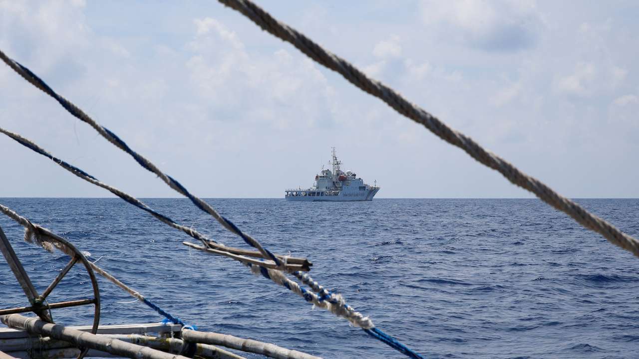 FILE PHOTO: A China Coast Guard ship is seen from a Philippine fishing boat at the disputed Scarborough Shoal