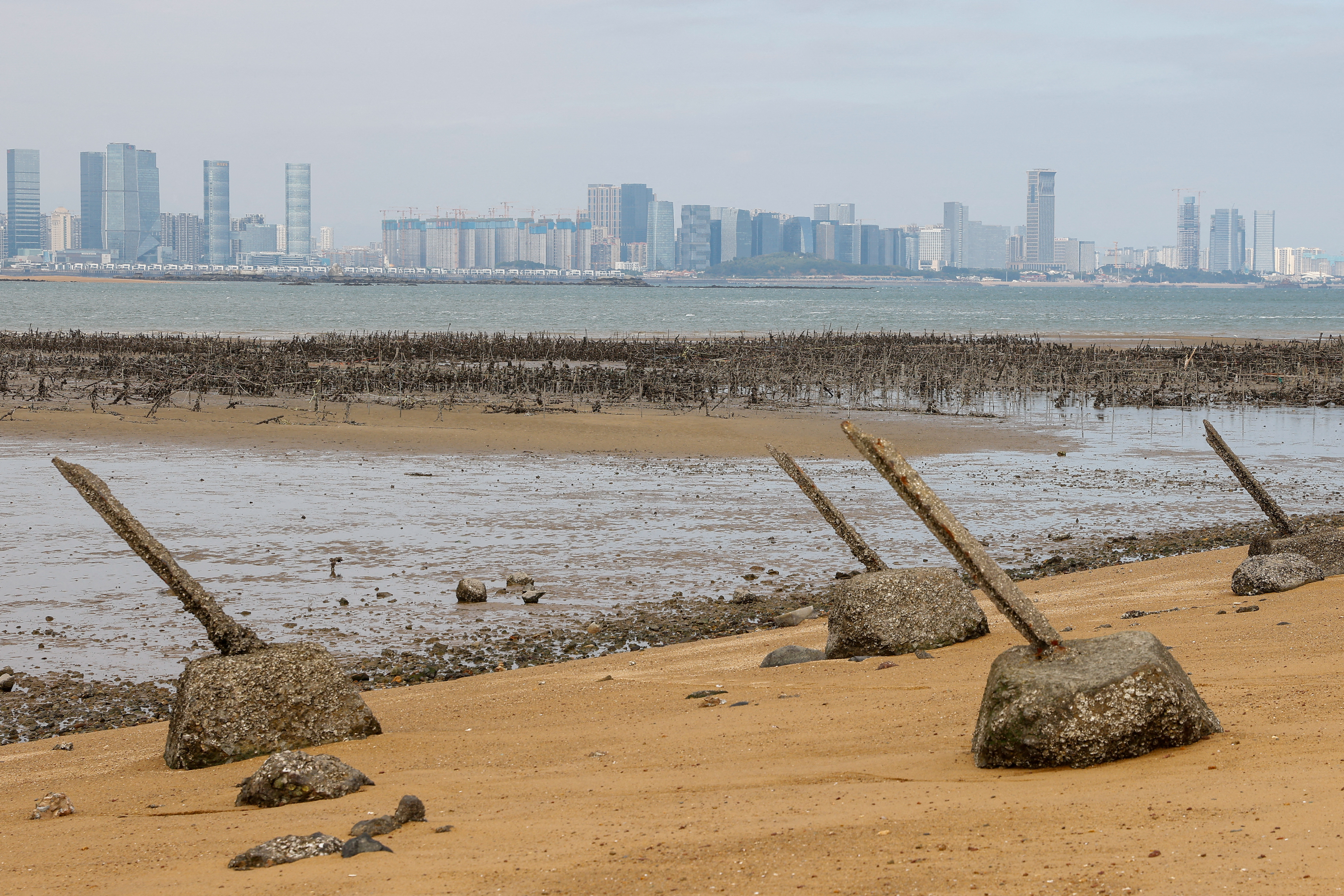 FILE PHOTO: Anti-landing barricades are seen on the beach with China's Xiamen in the background in Kinmen