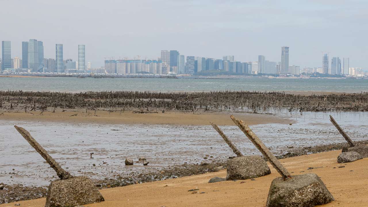 FILE PHOTO: Anti-landing barricades are seen on the beach with China's Xiamen in the background in Kinmen