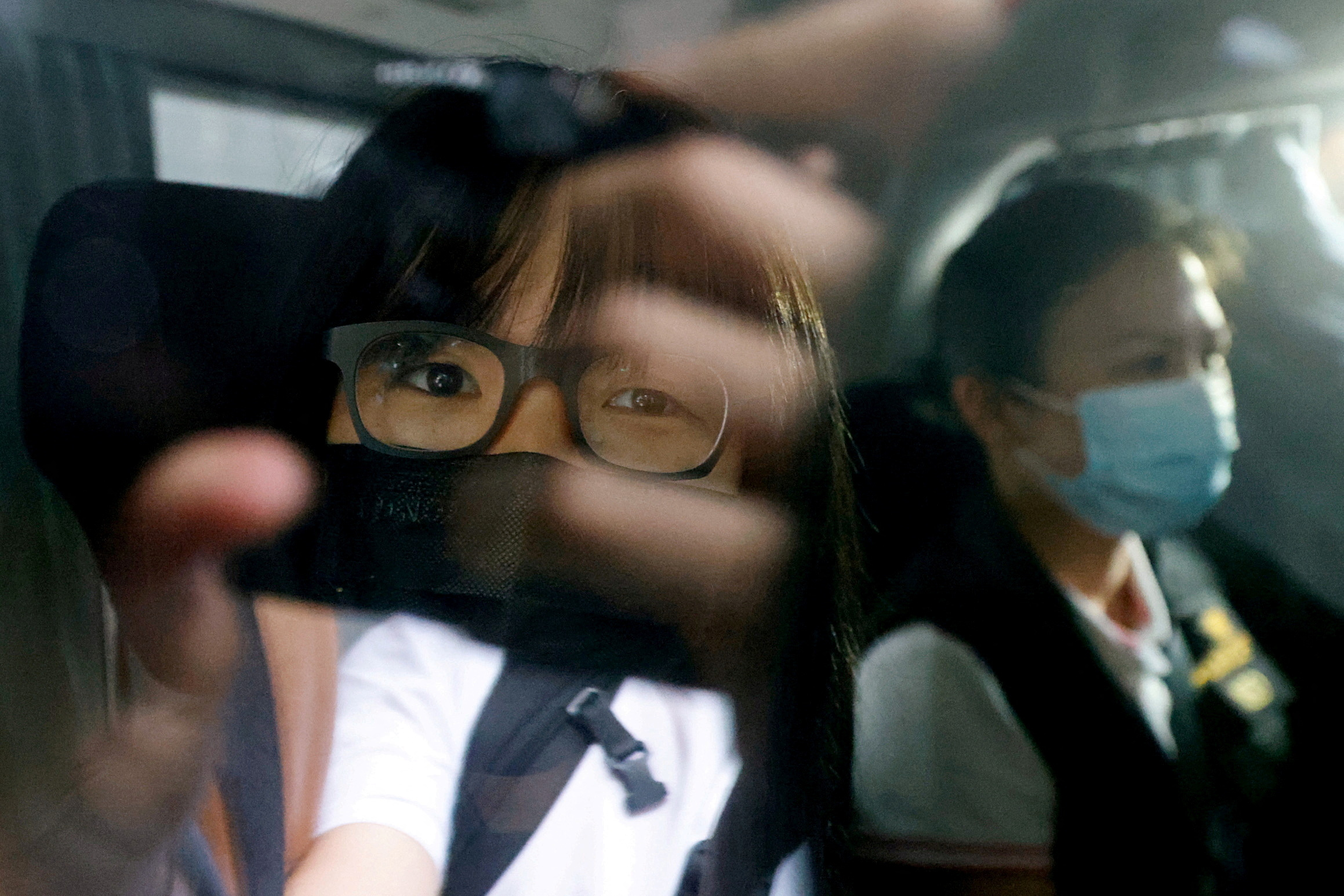 Hong Kong Alliance in Support of Patriotic Democratic Movements of China Vice-Chairwoman Tonyee Chow is seen inside a vehicle after being detained in Hong Kong