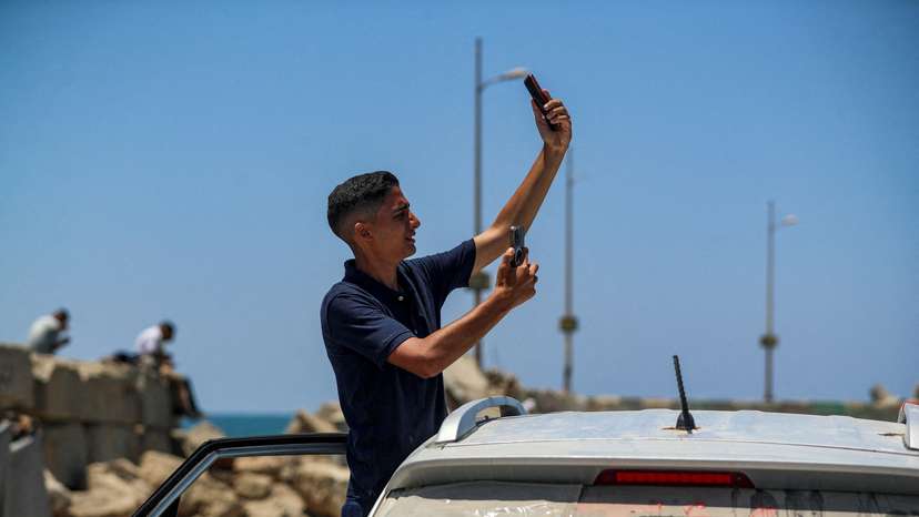 Palestinians attempt to access the internet using eSIMs, in Gaza City