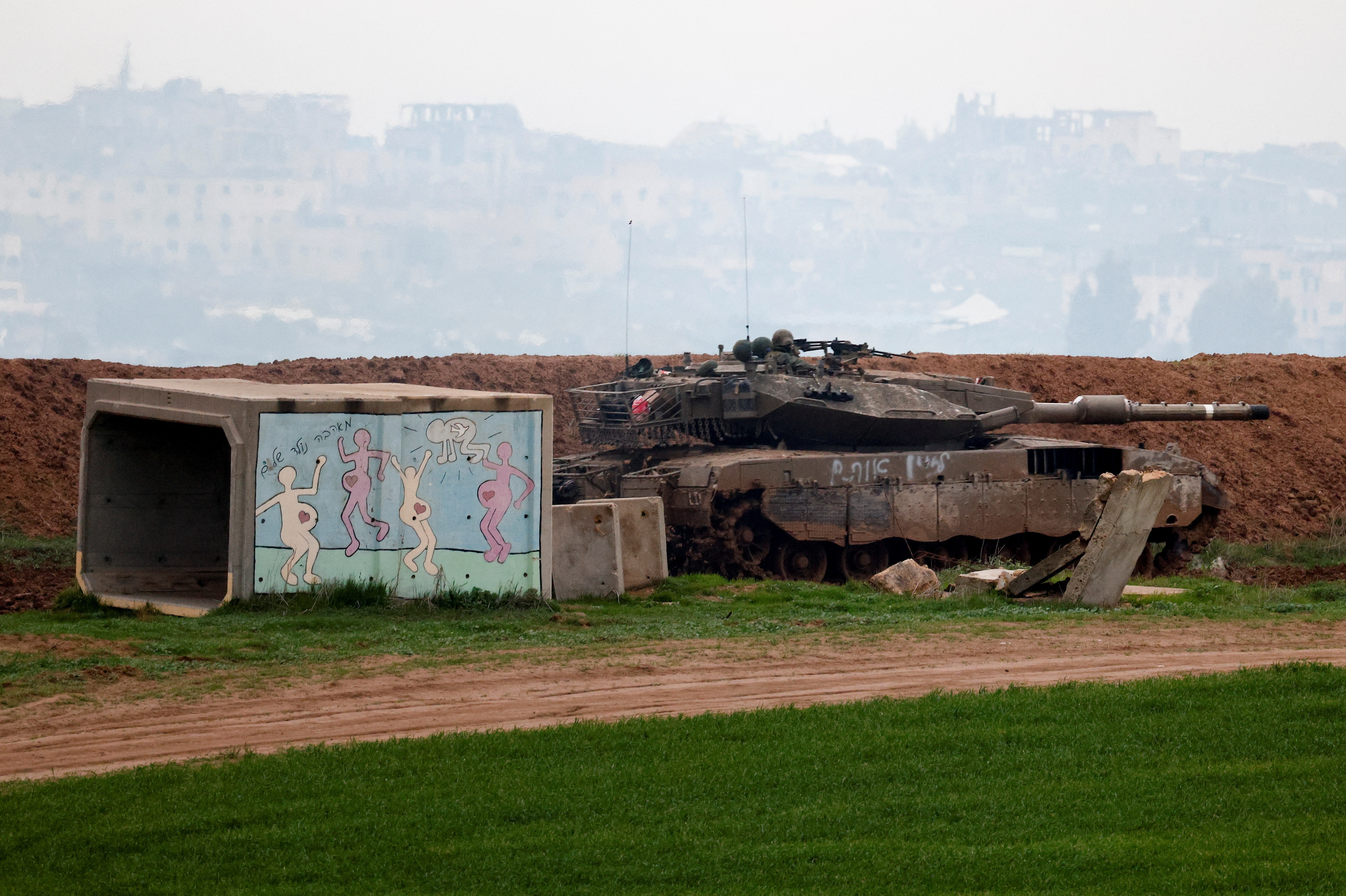 An Israeli tank manoeuvres on the Israeli side of the border with Gaza