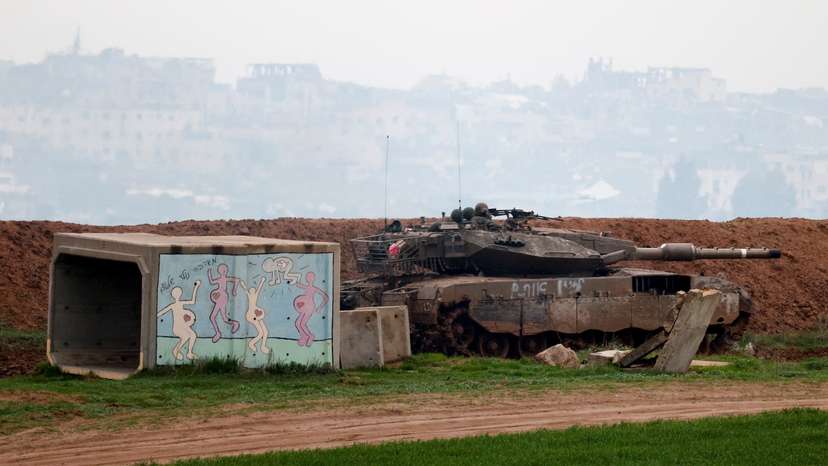 An Israeli tank manoeuvres on the Israeli side of the border with Gaza
