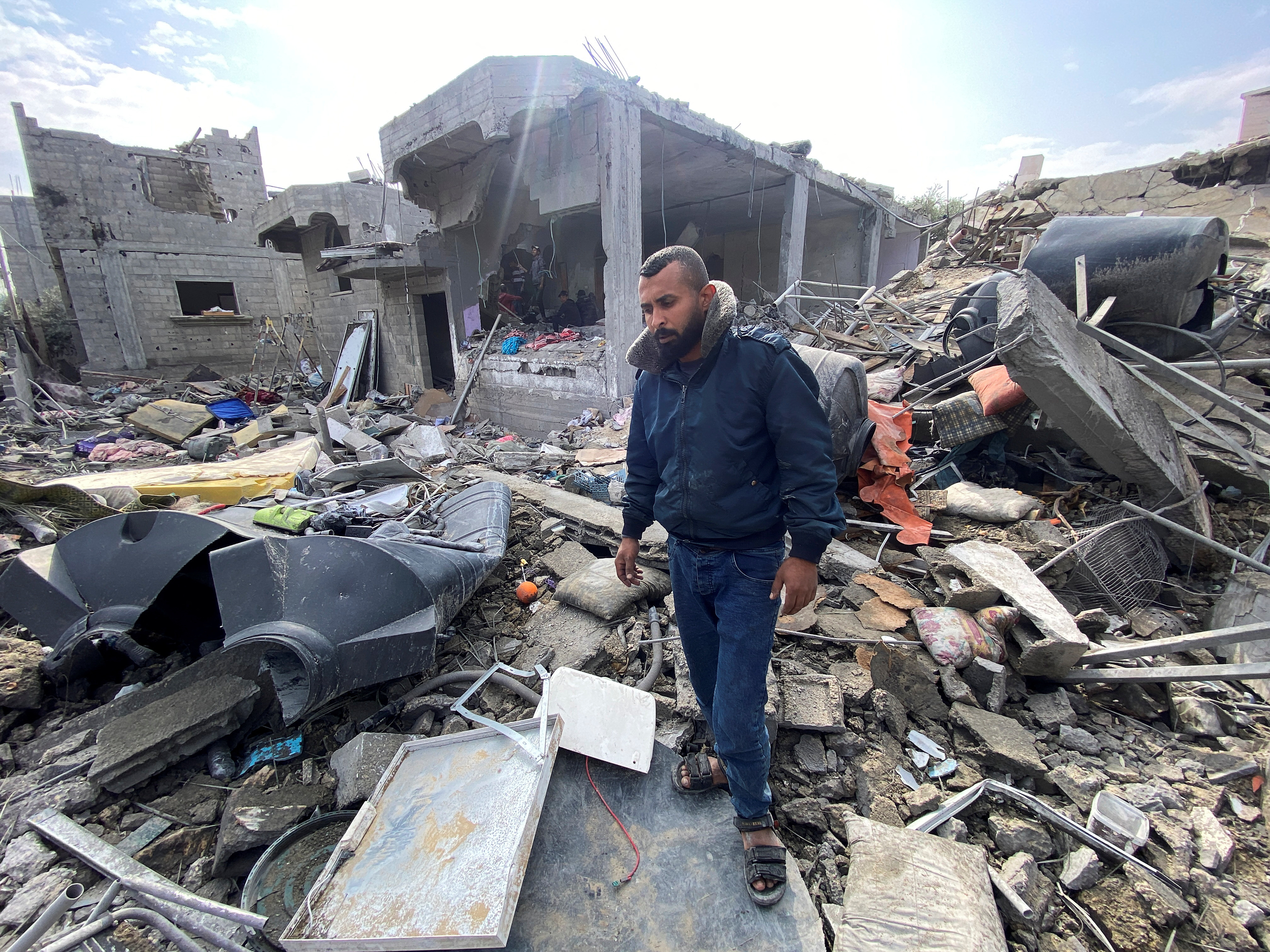 Palestinian man Ibrahim Al-Haj Youssef, who lost four of his children and his wife in an Israeli air strike, stands amidst debris, at the Maghazi camp