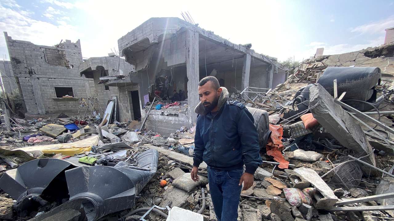 Palestinian man Ibrahim Al-Haj Youssef, who lost four of his children and his wife in an Israeli air strike, stands amidst debris, at the Maghazi camp