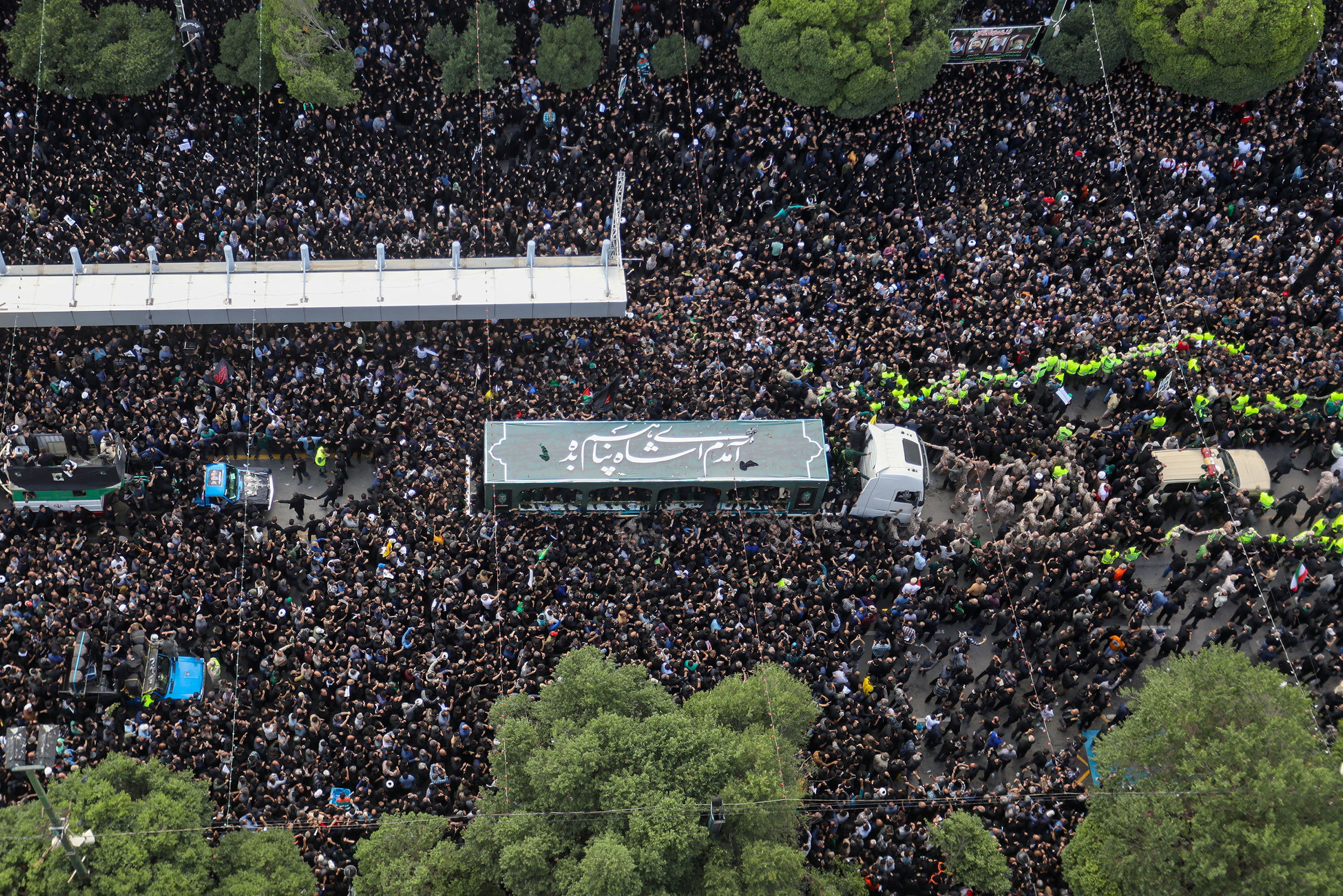 Mourners attend a burial ceremony of the late Iran's President Ebrahim Raisi in Mashhad