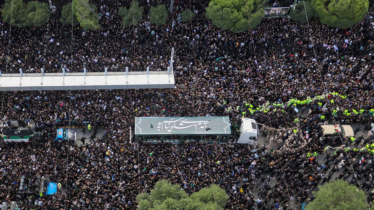 Mourners attend a burial ceremony of the late Iran's President Ebrahim Raisi in Mashhad