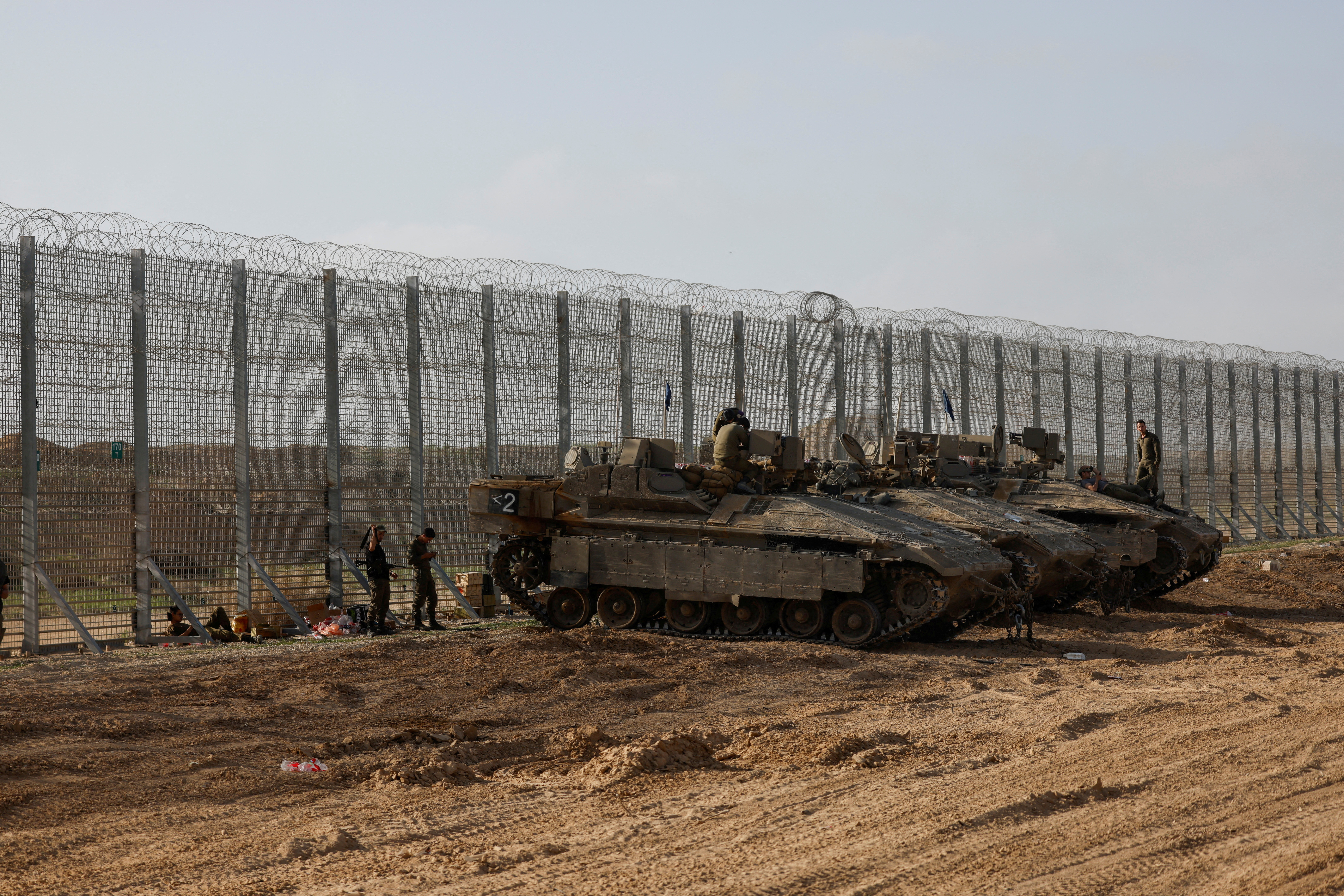 FILE PHOTO: Soldiers sit on top of APC's, at the Israel-Gaza border