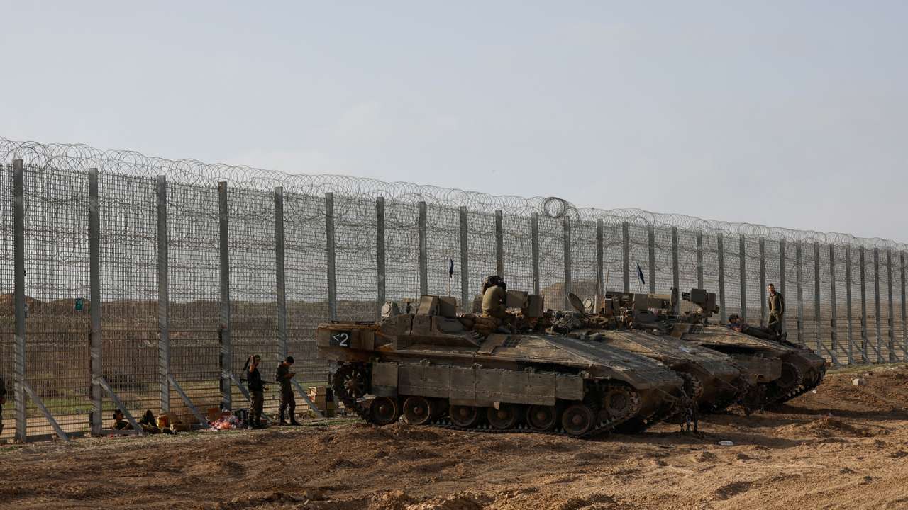FILE PHOTO: Soldiers sit on top of APC's, at the Israel-Gaza border