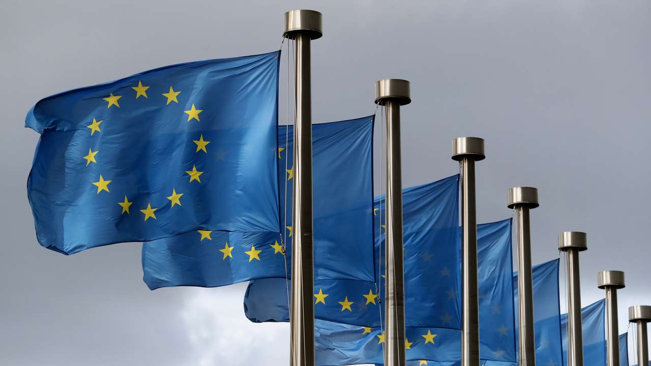 EU flags flutter in front of the European Commission headquarters in Brussels