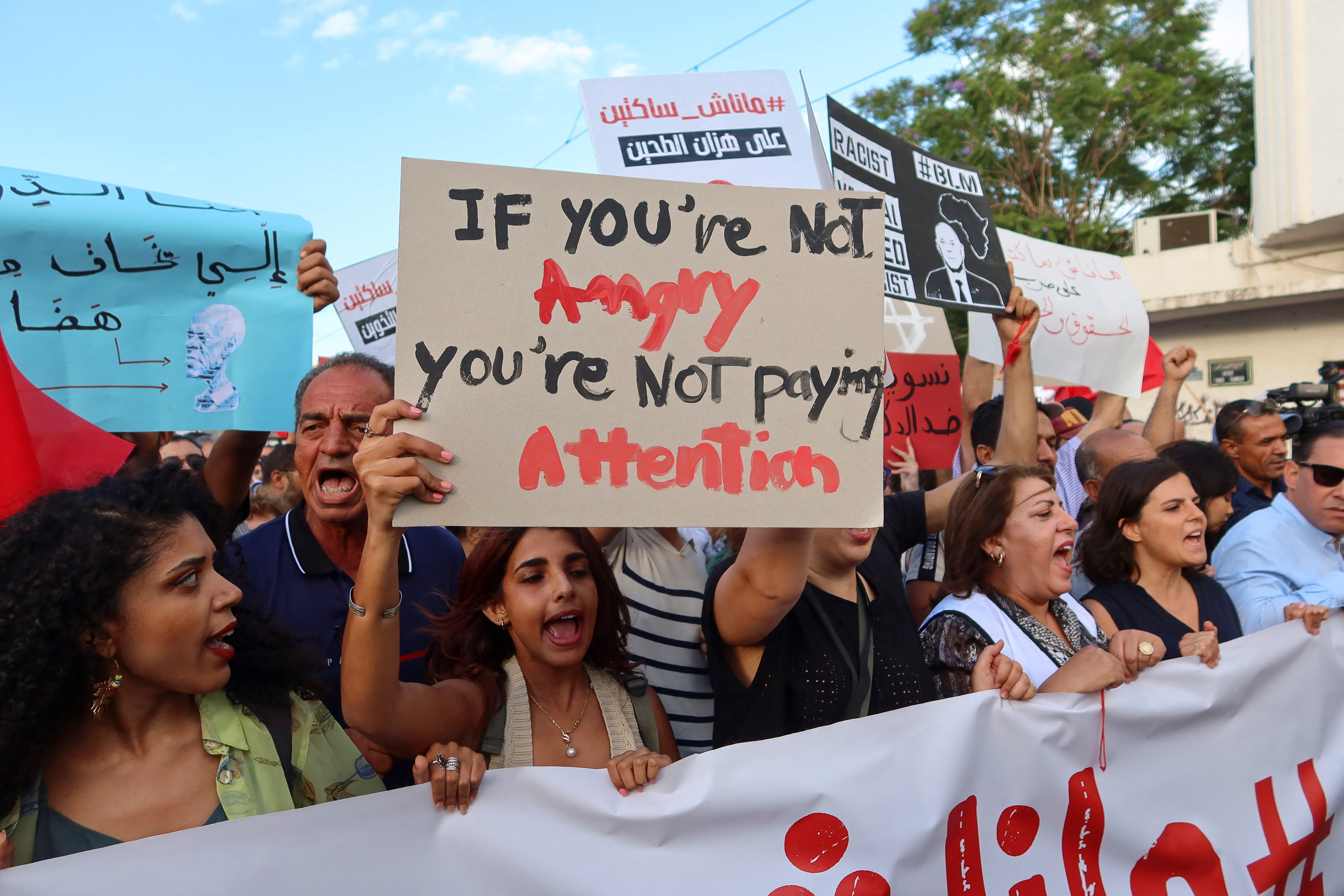 Demonstrators hold signs and chant slogans during a protest against President Kais Saied in Tunis