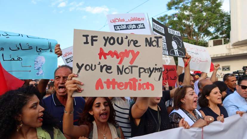 Demonstrators hold signs and chant slogans during a protest against President Kais Saied in Tunis