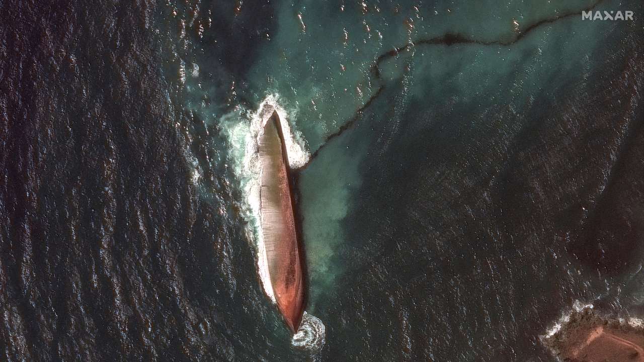 FILE PHOTO: A satellite image shows a close-up view of a capsized barge and an oil spill, off the shore of Tobago Island