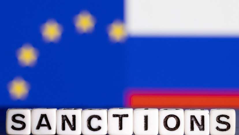 FILE PHOTO: Illustration shows letters arranged to read "Sanctions" in front of flag colors of EU and Russia