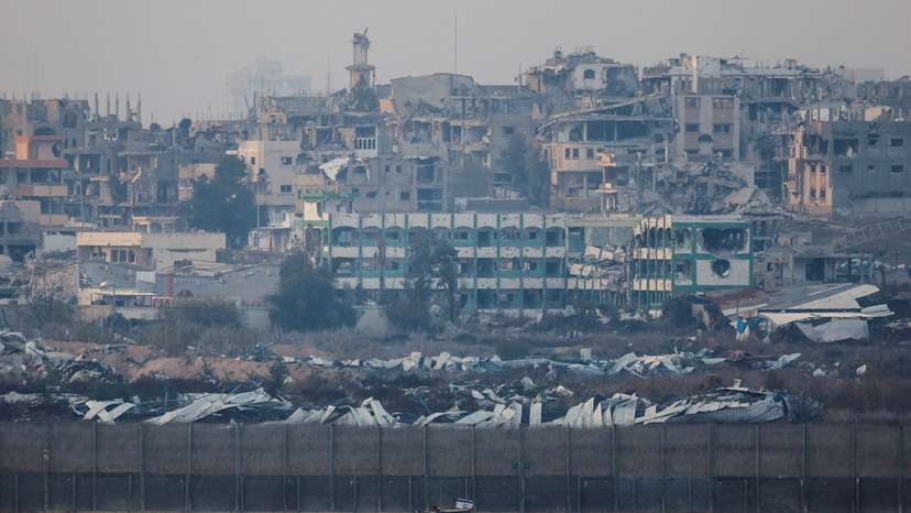 An Israeli military vehicles drives near the border with Gaza, as seen from the Israeli side of the border