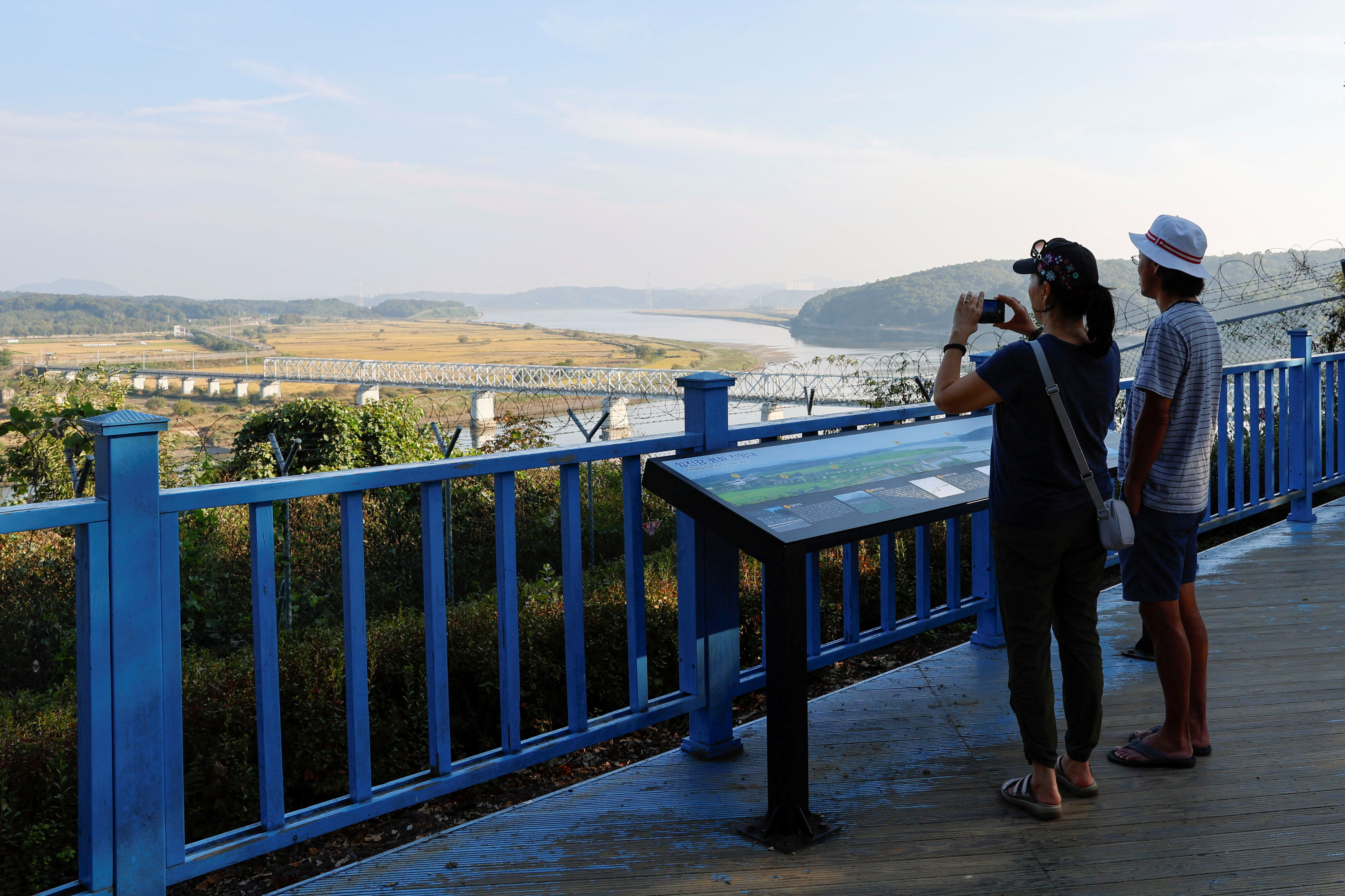 A visitor takes a picture of the Bridge of Freedom, which connects North Korea and South Korea, at the Imjingak pavilion near the demilitarized zone which separates the two Koreas, in Paju
