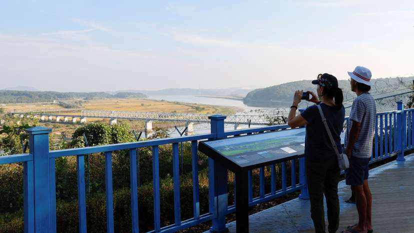 A visitor takes a picture of the Bridge of Freedom, which connects North Korea and South Korea, at the Imjingak pavilion near the demilitarized zone which separates the two Koreas, in Paju